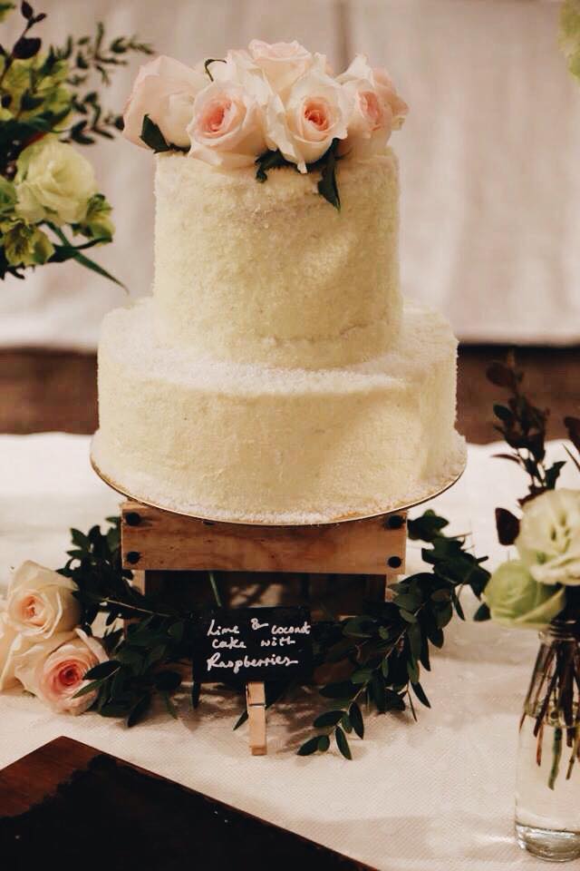 2 tiered lime, coconut and raspberry cake with fresh blushing roses